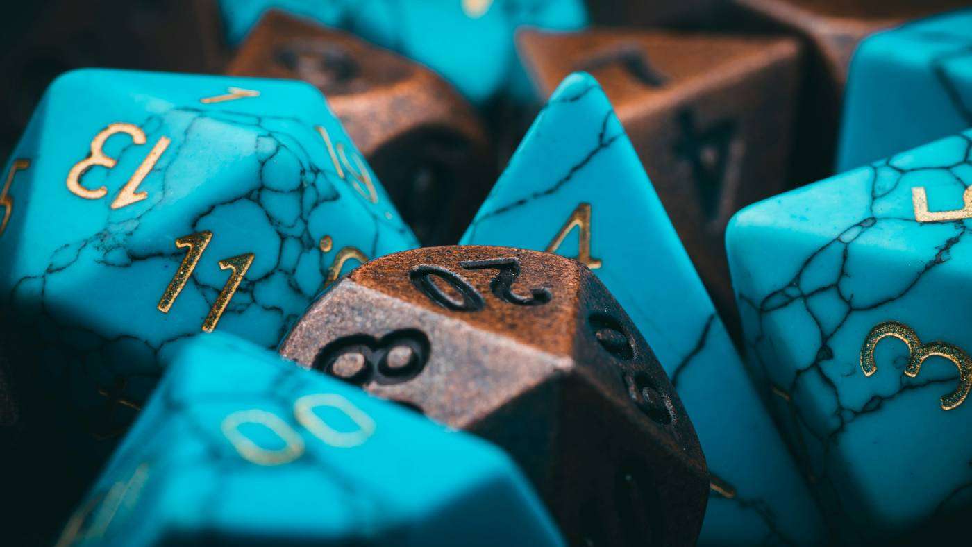 A group of blue and brown dice sitting on top of each other.