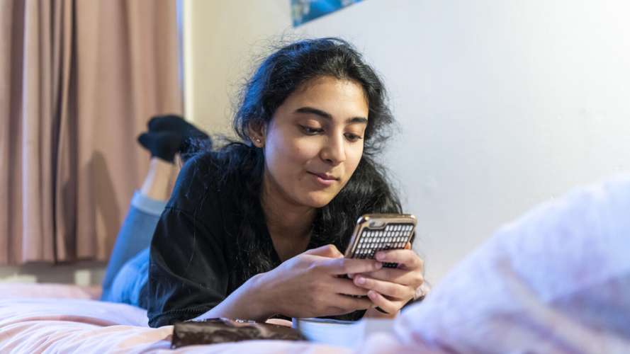 Student on the phone in their room
