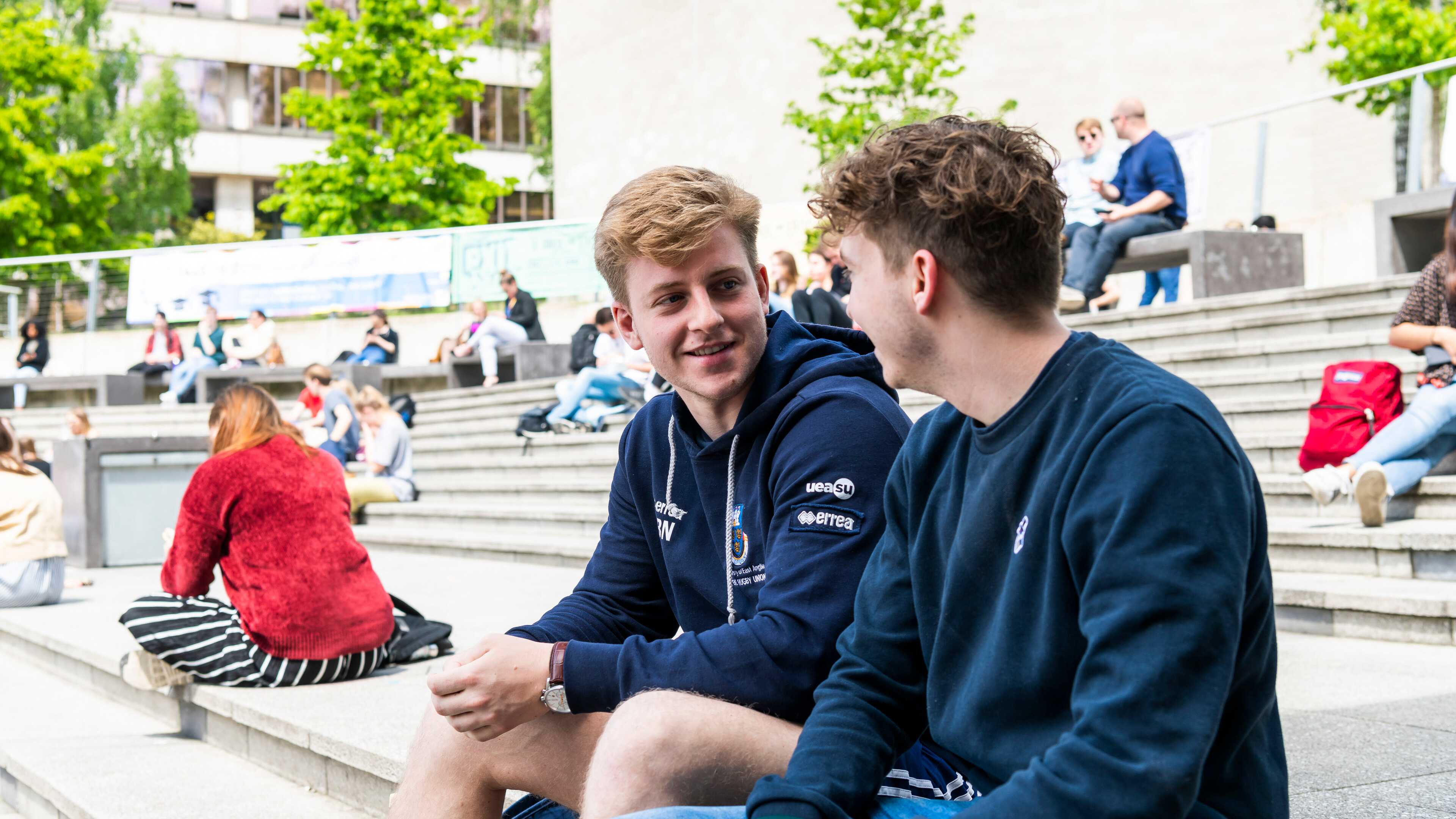 Two students talking in the Square
