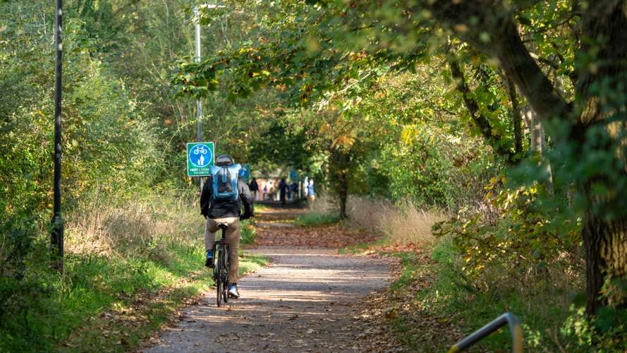 Cyclist biking down Cow Lane bike path
