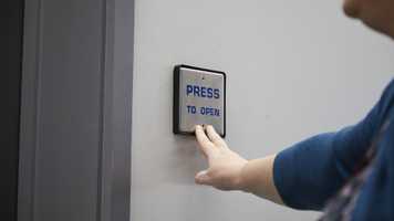 Push button on electric door in the New Science Building