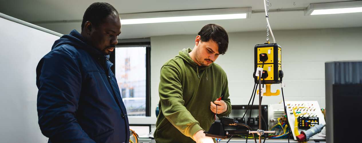 Student looking at a table with wires across it